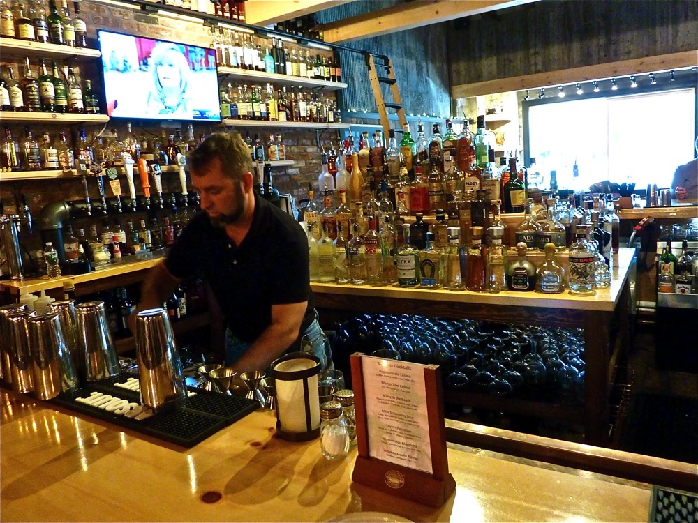 Benjamin Perry works the bar at The Charred Oak Tavern in Middleborough, Mass.