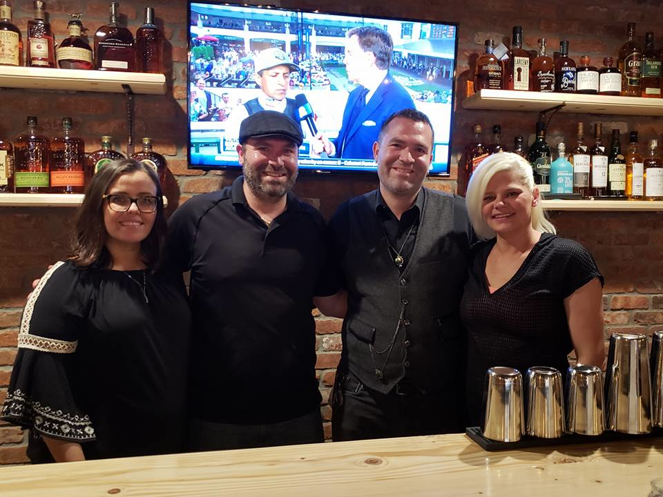 Matt and Michael Menard with wives Syliva (left) and Katrin (right) at Charred Oak Tavern in Middleboro, Mass.