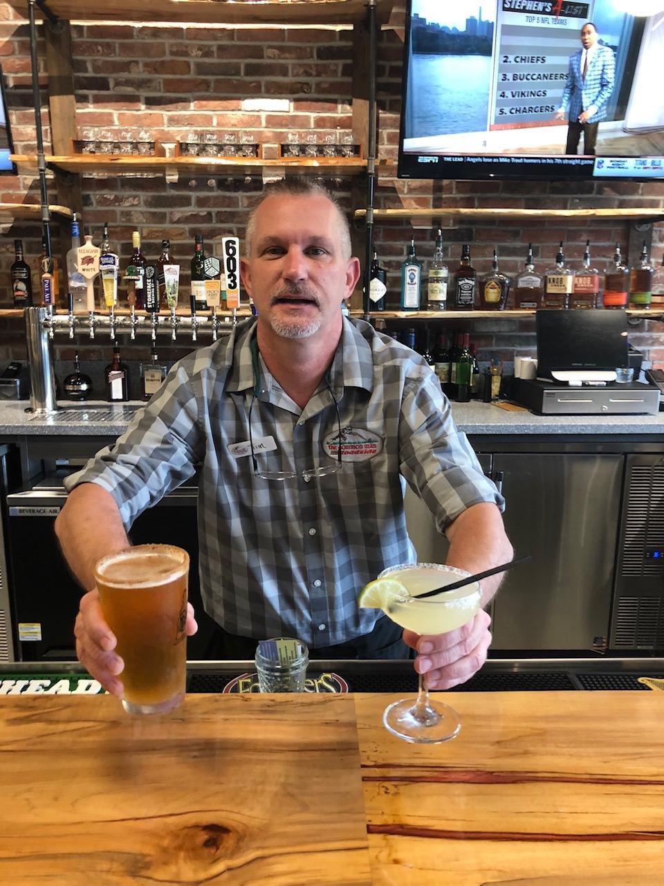 Bartender Tim McKinnon serves up a pumpkin ale and margarita at the Common Man Roadside Millyard in Manchester, N.H..
