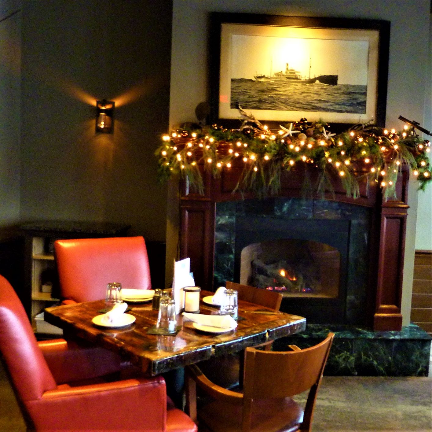 Dining area by the fireplace at DiMillo's On the Water in Portland, Maine.