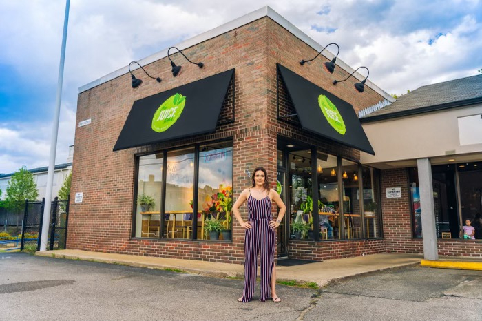 Marcieli Pastorio stands in front of her new Juice Bar location in Norwood, Massachusetts.